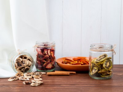 side-view-various-dried-sliced-fruits-glass-jars-banana-kiwi-strawberry-wooden-background_400x300